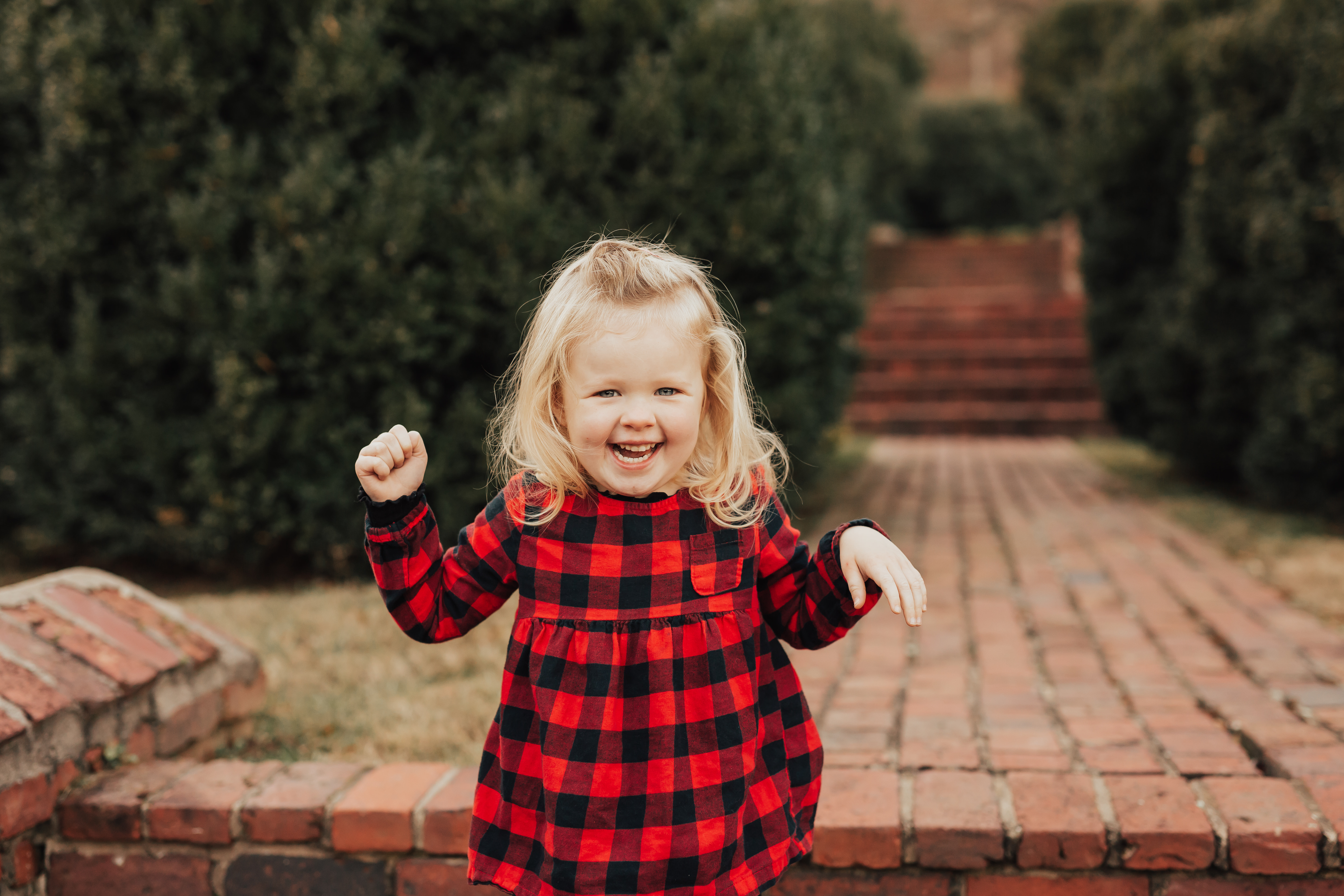 excited little girl on brick steps at Morven Park