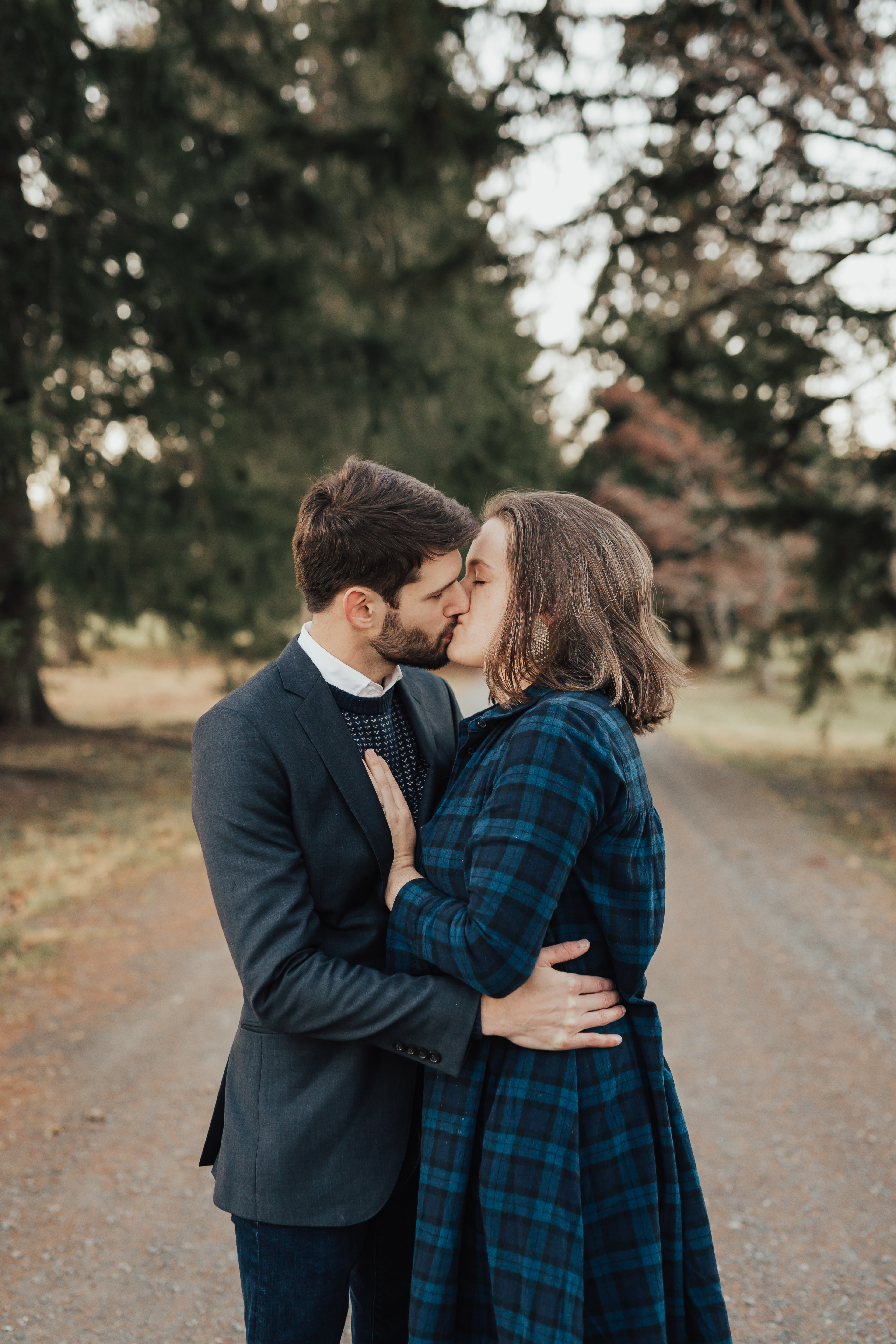 Couple kissing each other on a dirt road