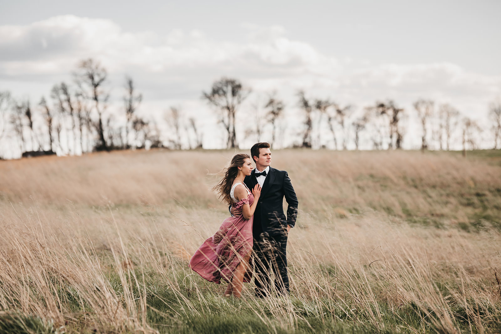 photo of a engaged couple in a field