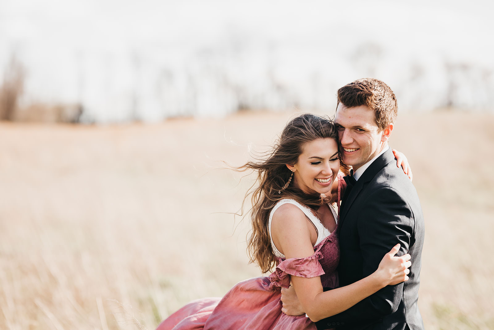 photo of a couple smiling and hugging
