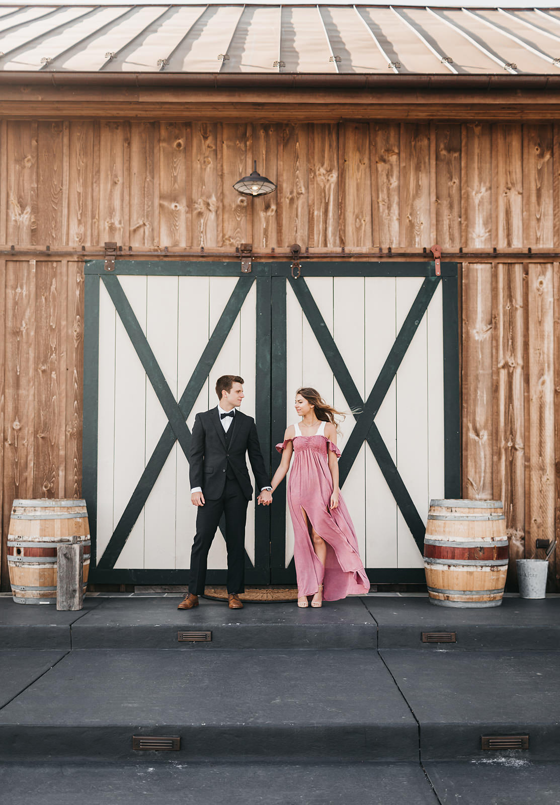 photo of a engaged couple in front of a barn