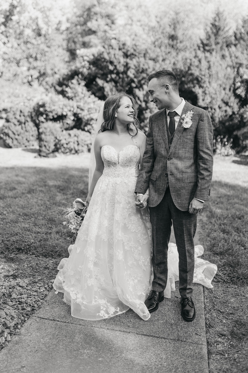 Black and white photo of bride and groom smiling at each other during their wedding shoot with Rachel Yearick Photography