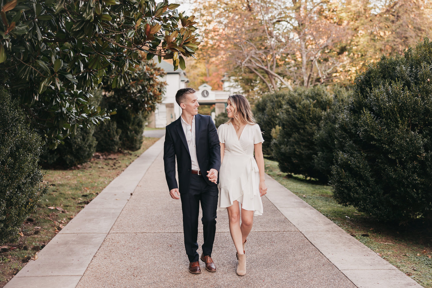 How to Choose a Wedding Photographer (Everything You Need to Know): Couple holding hands as they walk together during their engagement session.