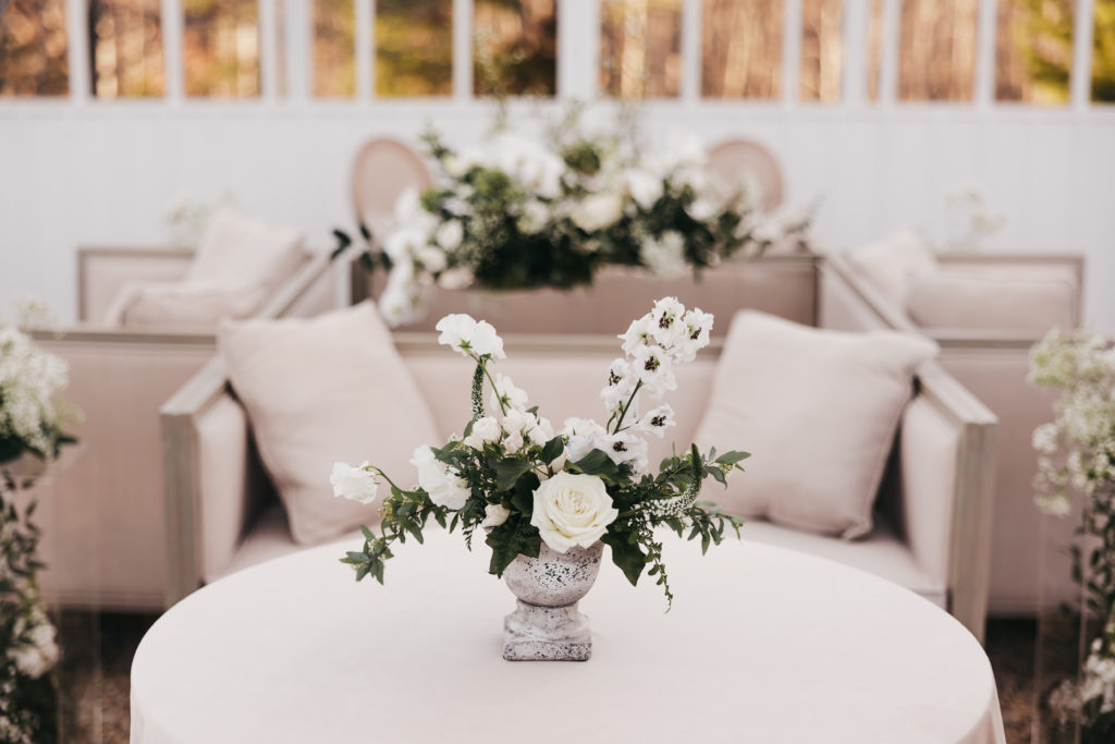 Elegant floral arrangements on table in glass enclosed verandah at Pippin Hill Farm & Vineyards, taken by Rachel Yearick Photography
