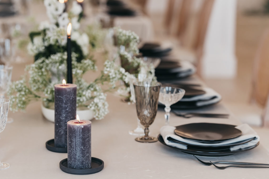 Top 6 Virginia Wedding Venues + Pricing. Close-up shot of table setting with candles and floral centerpieces.