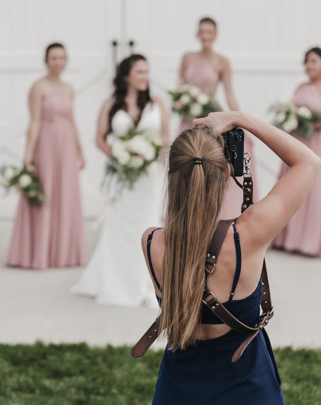 Rachel Yearick taking photo of bride and bridesmaids; What To Look For When Choosing Between Christian wedding Photographers