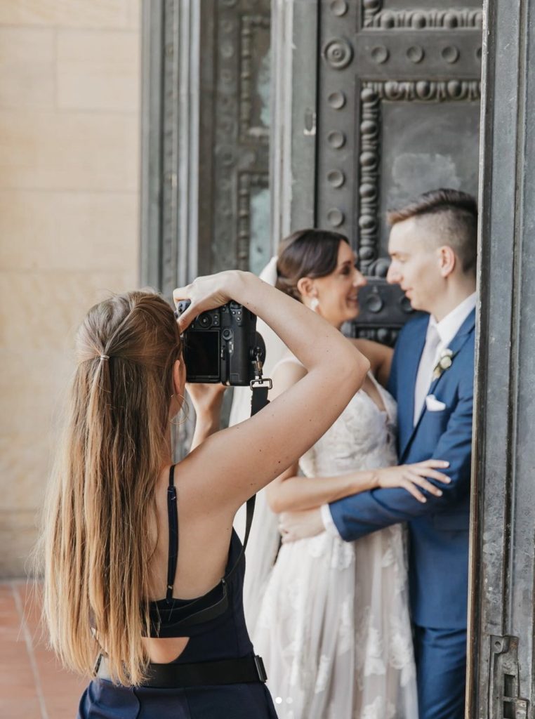 Rachel Yearick taking photo of couple during their wedding shoot