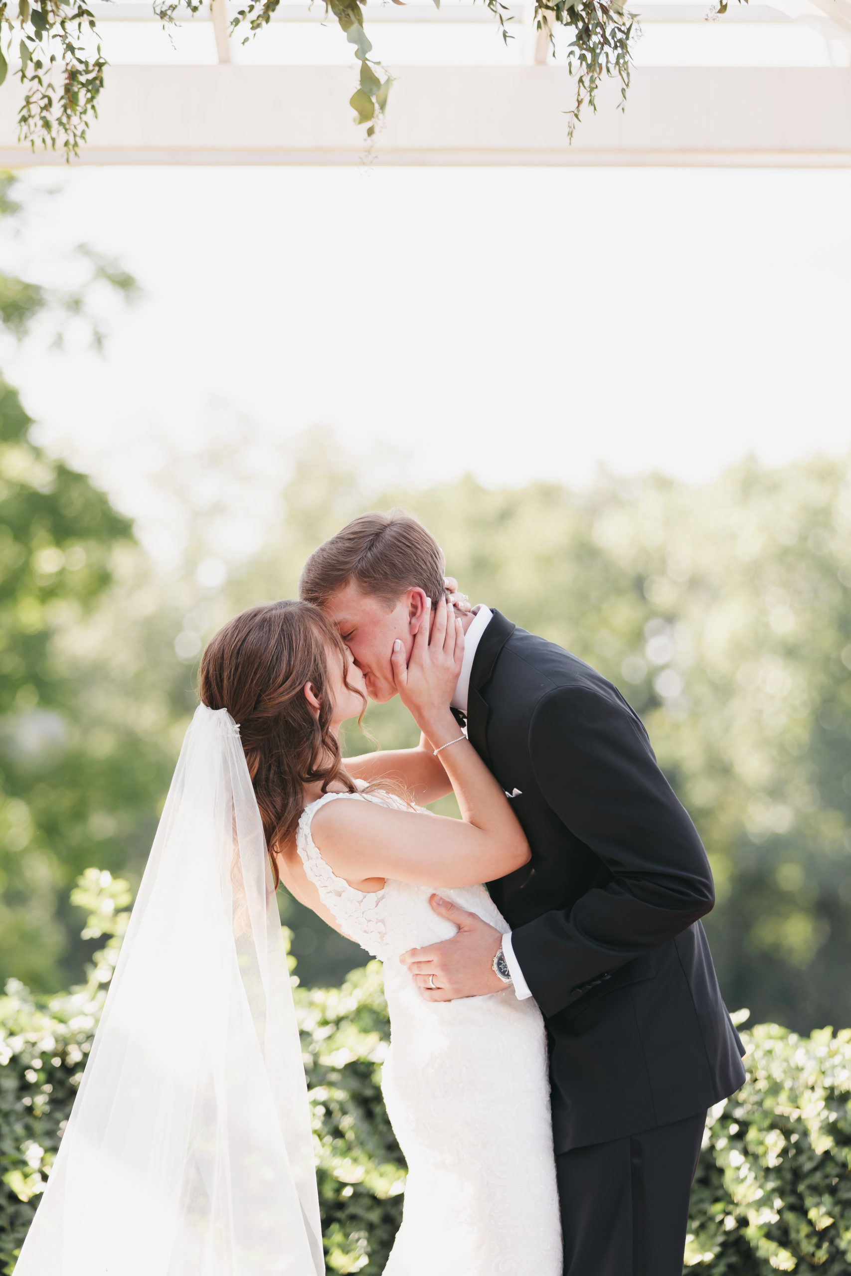 Bride and groom sharing a kiss during their timeless wedding shoot with Rachel Yearick Photography