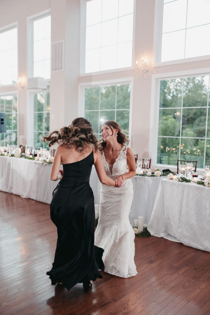 Bride dancing with her bridesmaids at the reception, captured by Rachel Yearick Photography