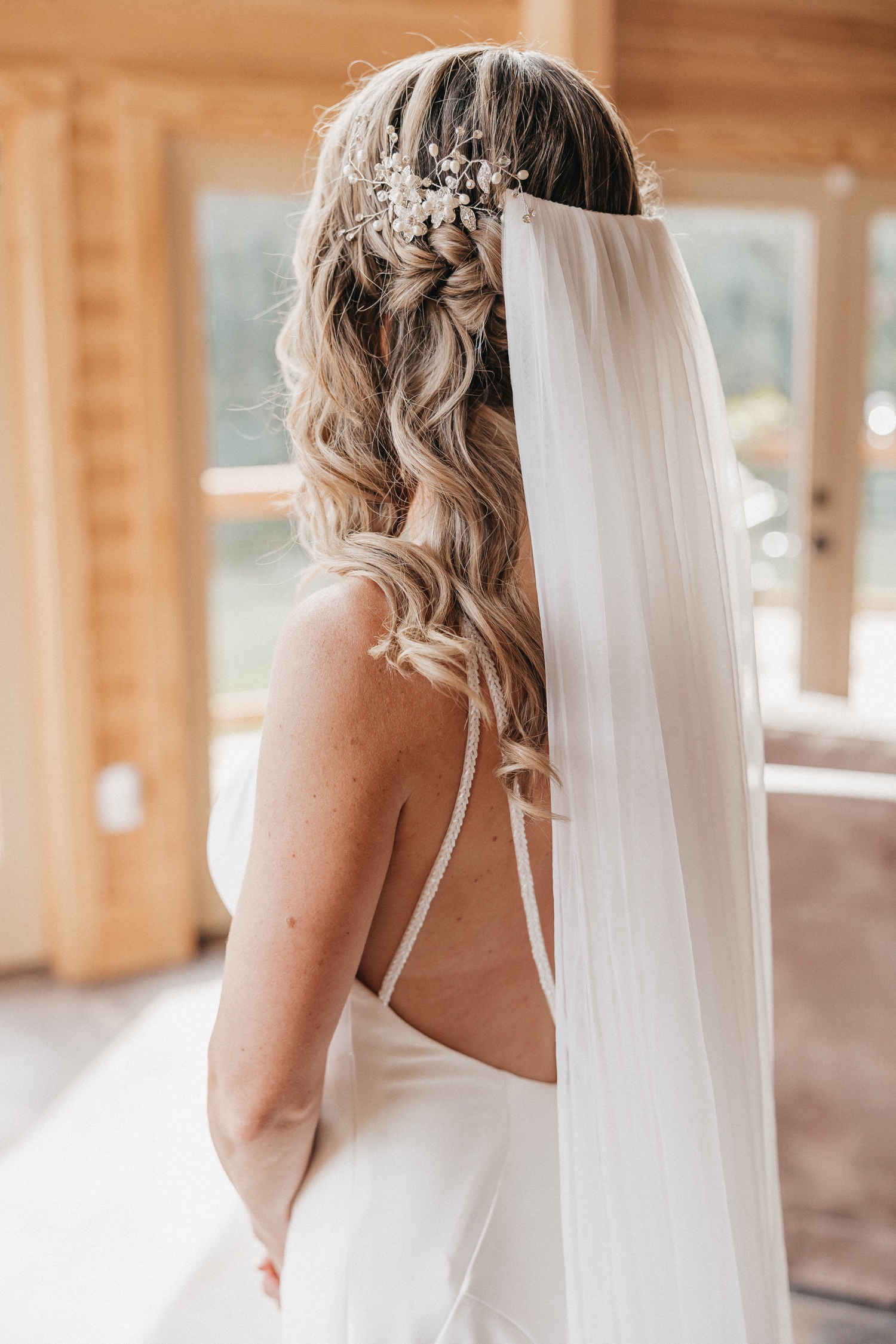Close-up shot of bride's hair, veil and dress, captured by Rachel Yearick Photography