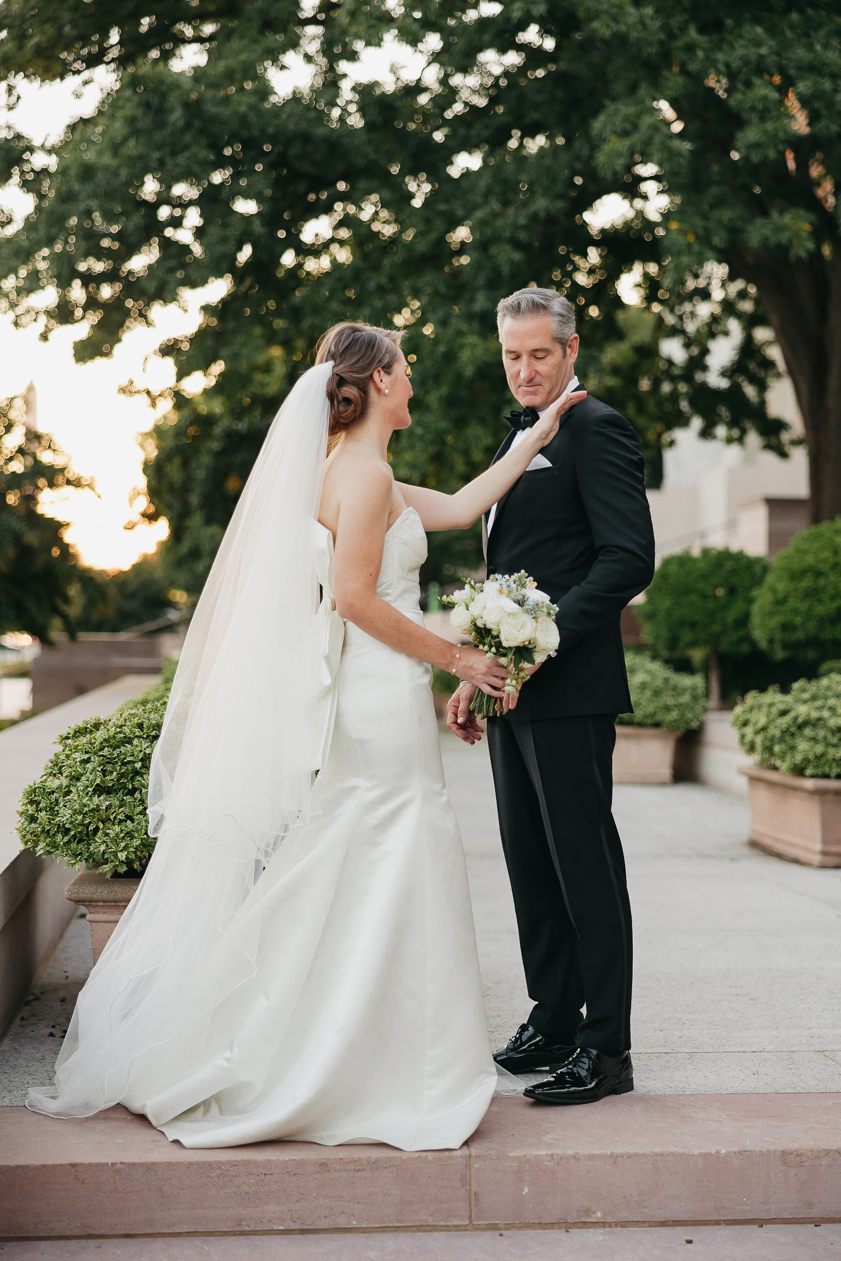 10 Christian Wedding Songs of 2023. Bride tapping groom's shoulder during their candid wedding shoot with Rachel Yearick Photography