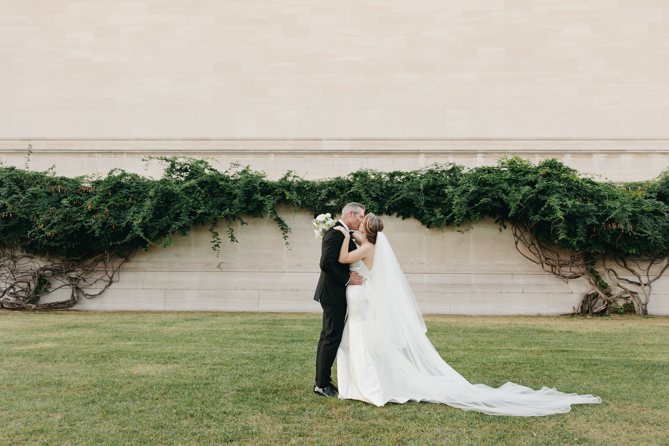 Newlywed couple sharing a kiss during their wedding shoot with Virginia wedding photographer Rachel Yearick