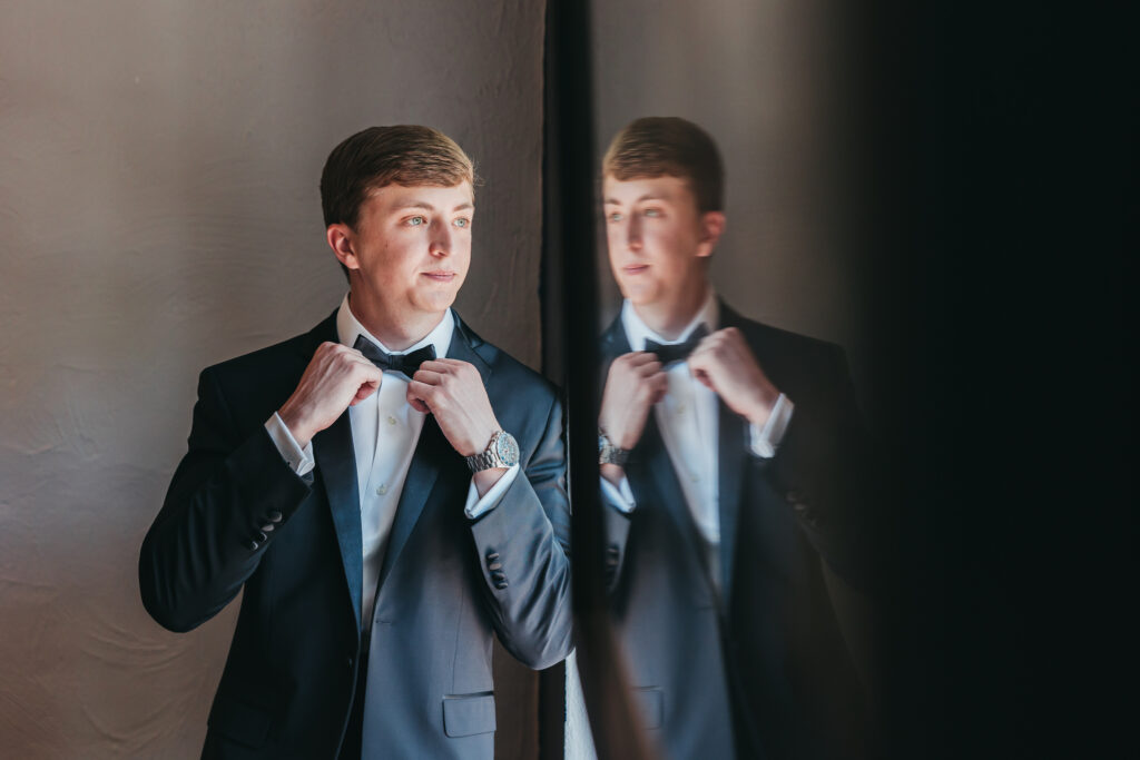 Groom reflection photo in the getting ready space at Poplar Springs Manor taken by Rachel Yearick Photography