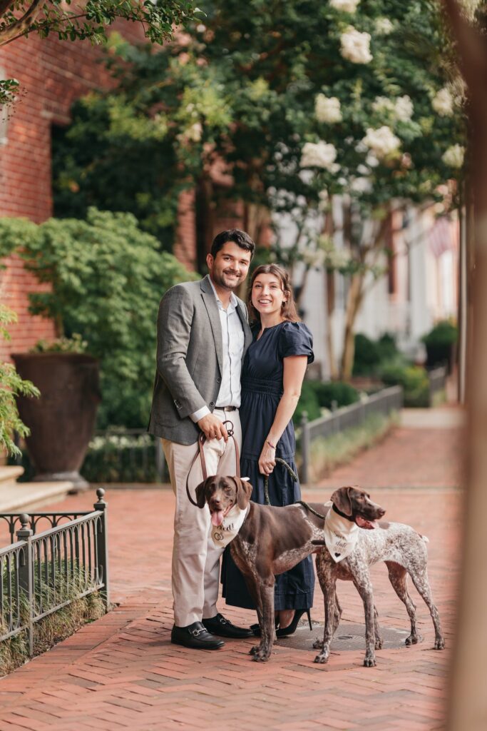 Couple standing while holding their dogs for their engagement photo with Rachel Yearick Photography
