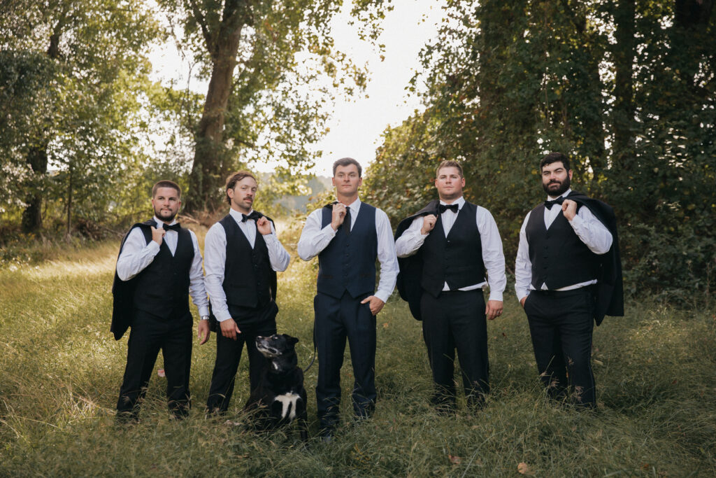 Groomsmen standing with their dog for wedding day photos with Rachel Yearick Photography
