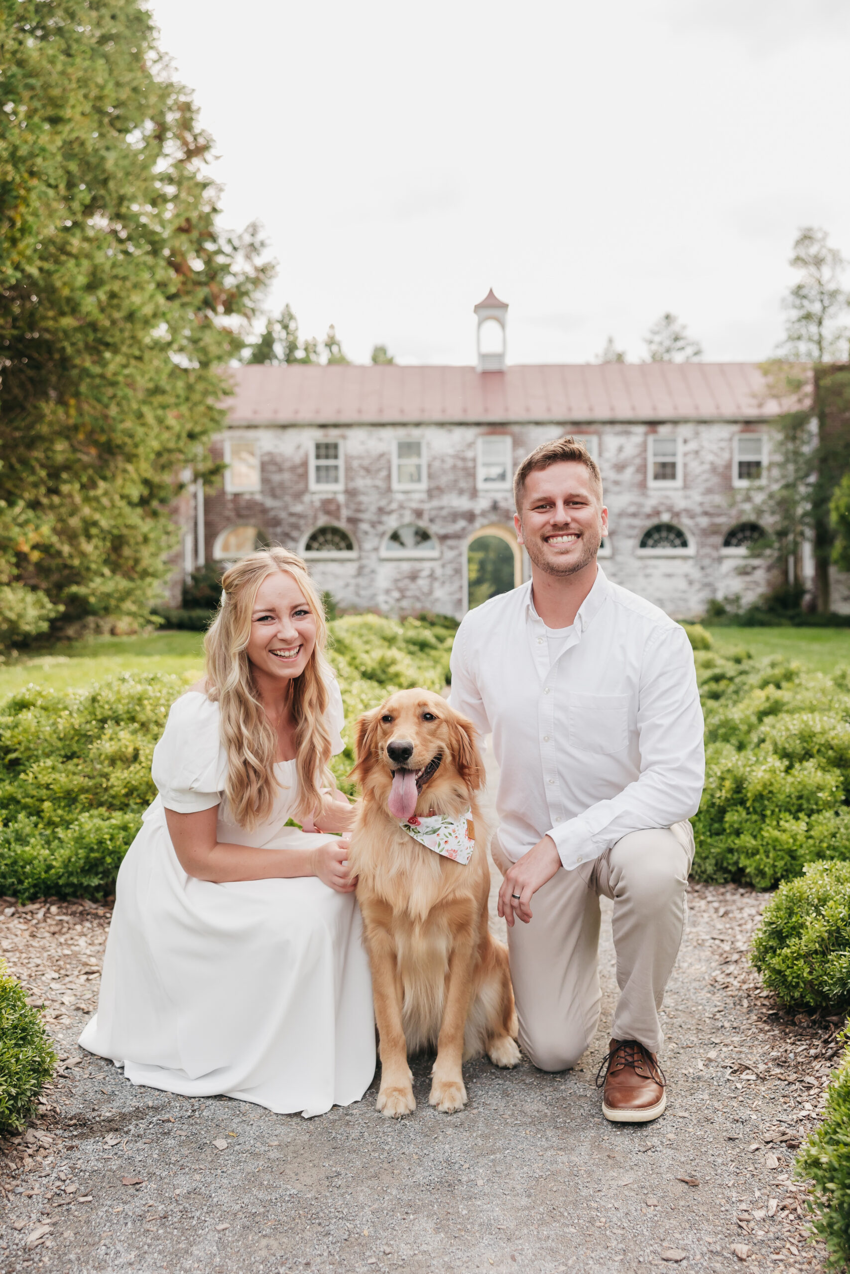 couple kneeling next to their dog for their engagement photos with Rachel Yearick Photography