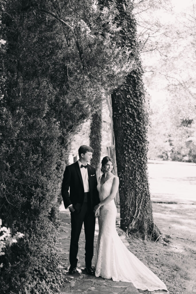 Couple standing in a beautiful, ivy filled first look spot at Poplar Springs Manor in Warrenton, Virginia