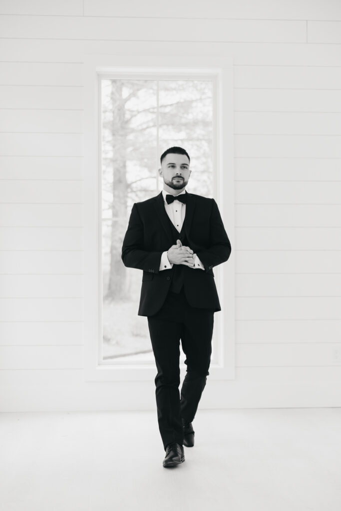 groom walking while rubbing his hands 
