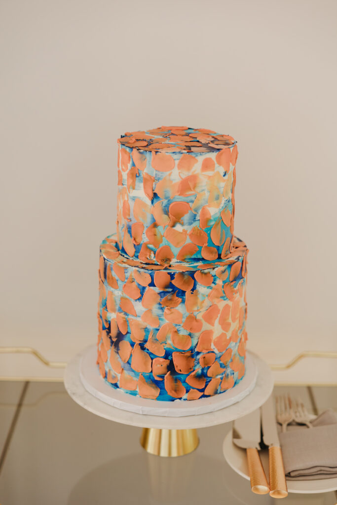 custom art inspired wedding cake with orange and blue highlights