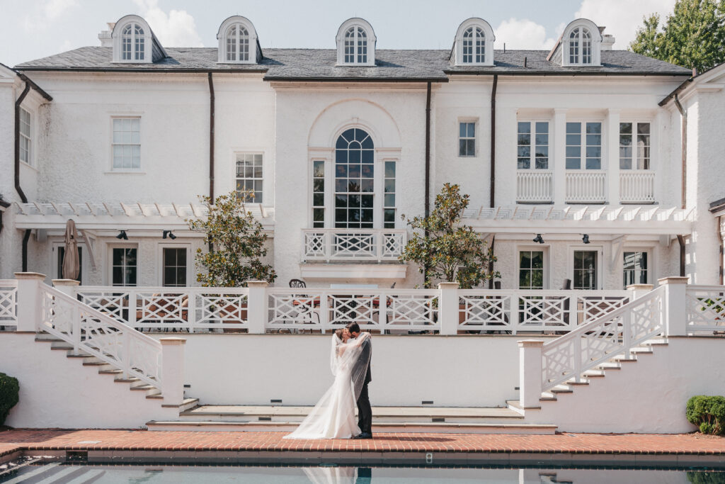 Couple Embracing in Front of Pool at Keswick Vineyards