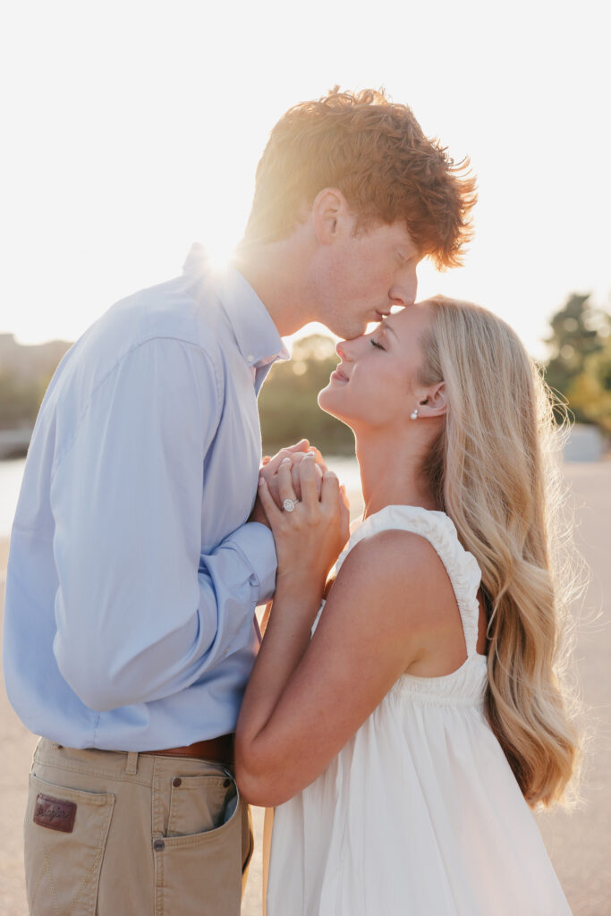 couple kissing in washington dc with the sun peeking through