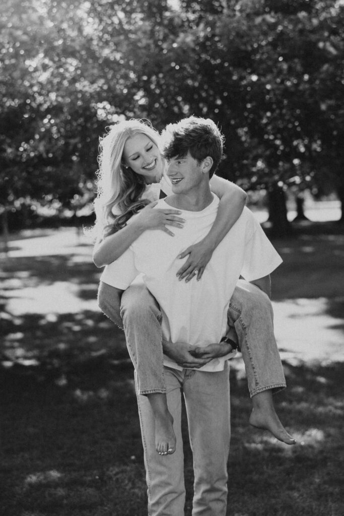 couple frolicking in a field in dc in white t-shirts and jeans