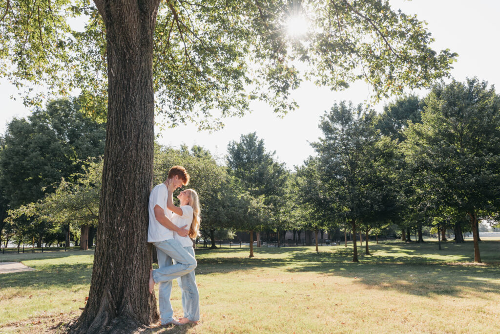 Natural candid of engaged couple laughing under the trees in Washington, D.C.