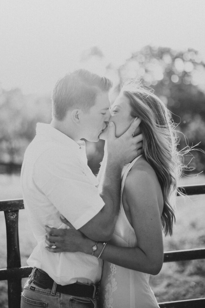 Romantic engagement photo of couple kissing in countryside in Bluemont, Virginia