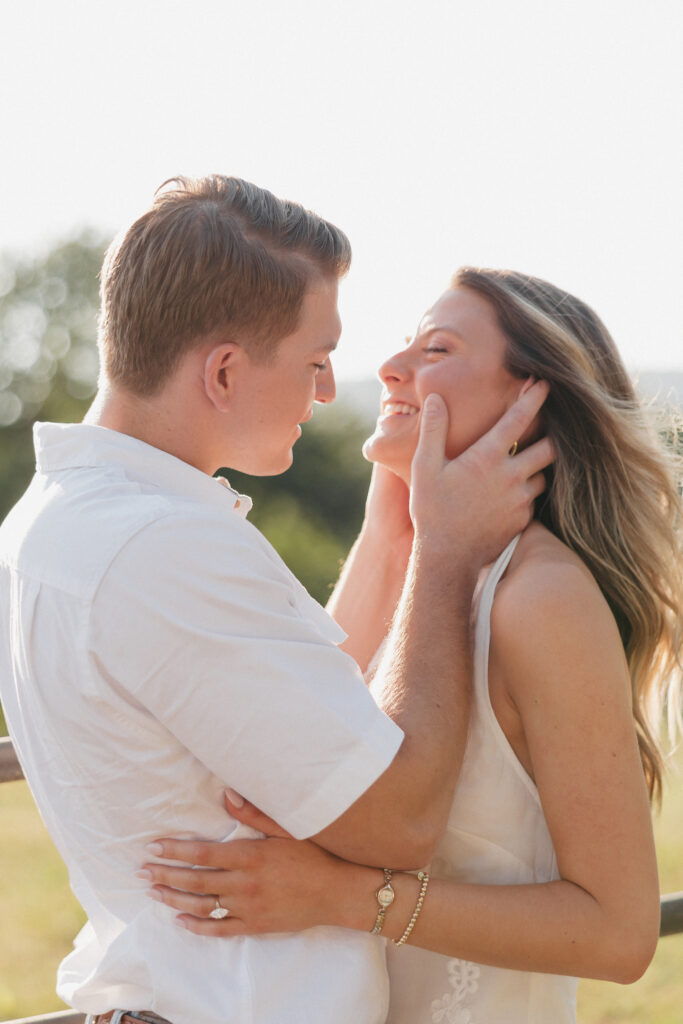 Romantic engagement photo of couple kissing in countryside in Bluemont, Virginia