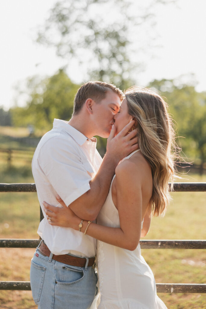 Romantic engagement photo of couple kissing in countryside in Bluemont, Virginia