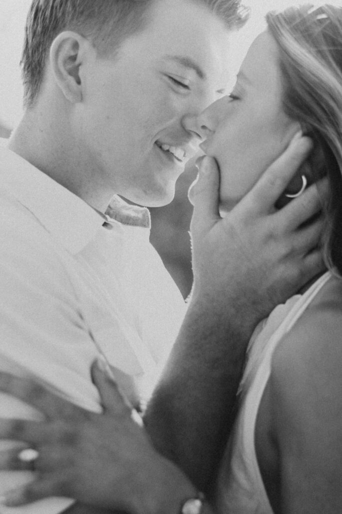 man kissing his fiance during their late-summer engagement session in the Virginia countryside