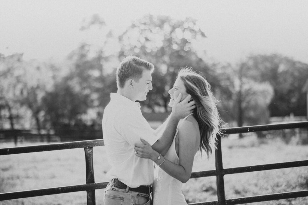 Joyful couple kissing during their late-summer engagement session in the Virginia countryside
