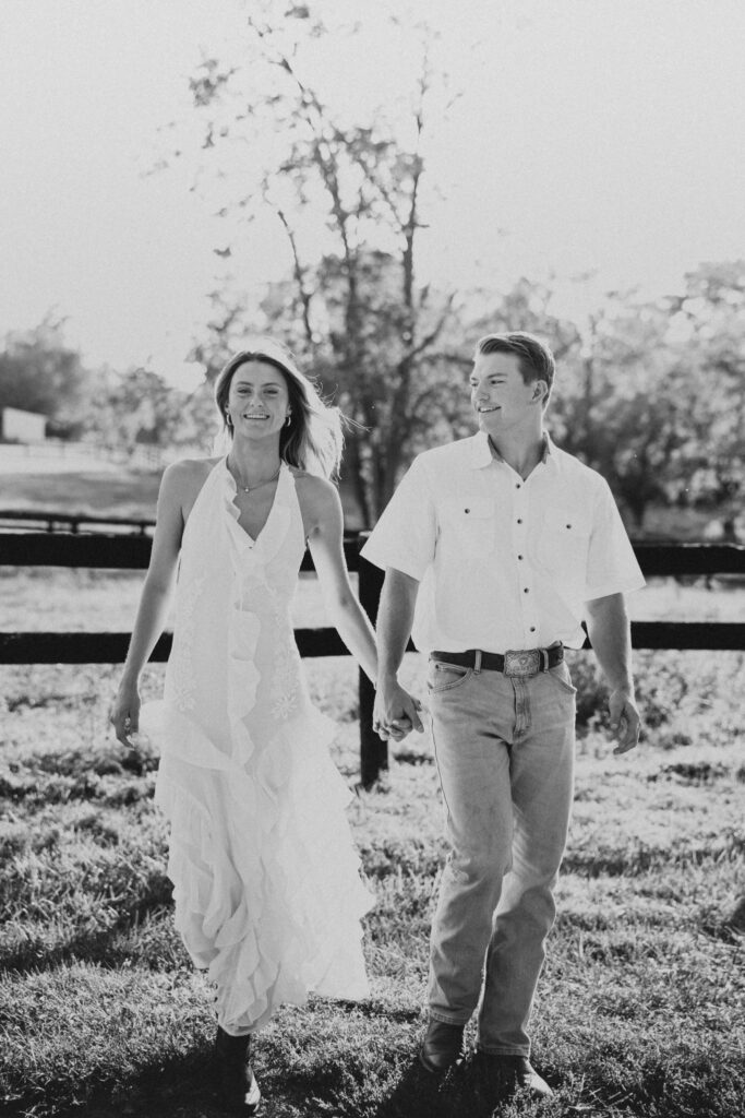 Joyful couple walking during their late-summer engagement session in the Virginia countryside