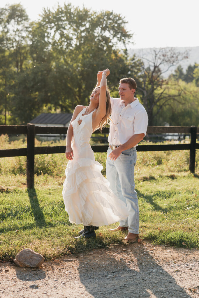 Romantic engagement photo of couple dancing in countryside in Bluemont, Virginia