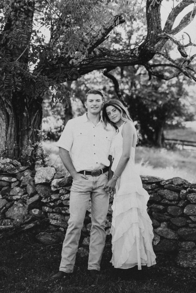 Refined western-style engagement outfit inspiration — white ruffled dress and boots for her, crisp shirt and denim for him