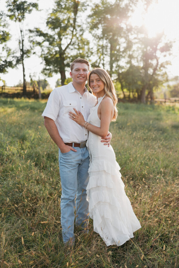 Refined western-style engagement outfit inspiration — white ruffled dress and boots for her, crisp shirt and denim for him