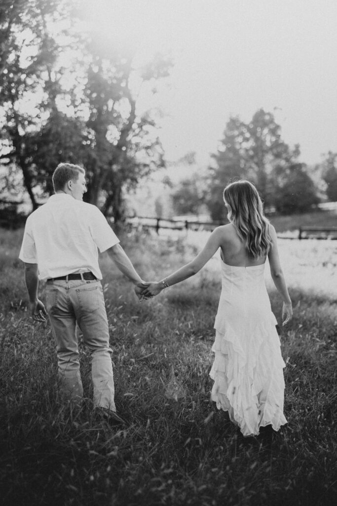 Refined western-style engagement outfit inspiration — white ruffled dress and boots for her, crisp shirt and denim for him