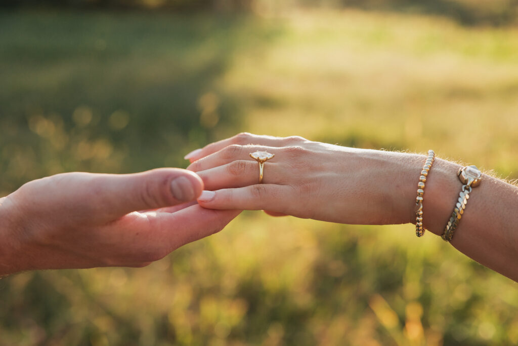Engagement ring photo of couple during their late-summer engagement session in the Virginia countryside.