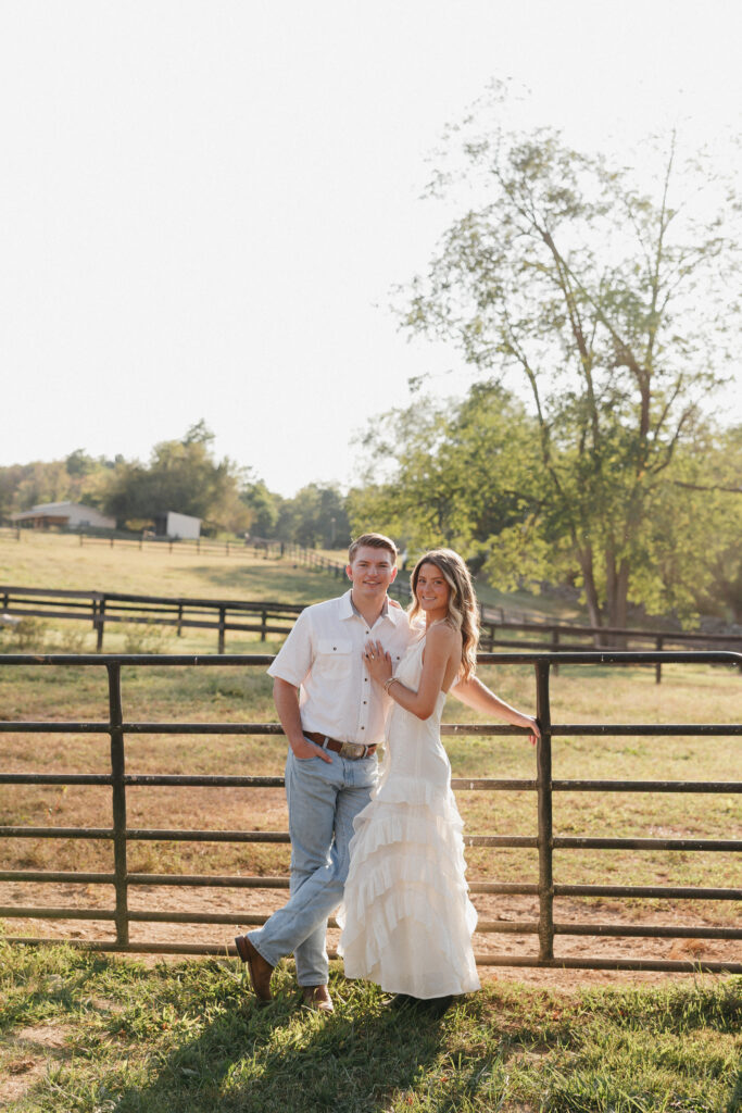 Romantic engagement photo capturing elegant western charm and countryside textures and fence in Bluemont, Virginia