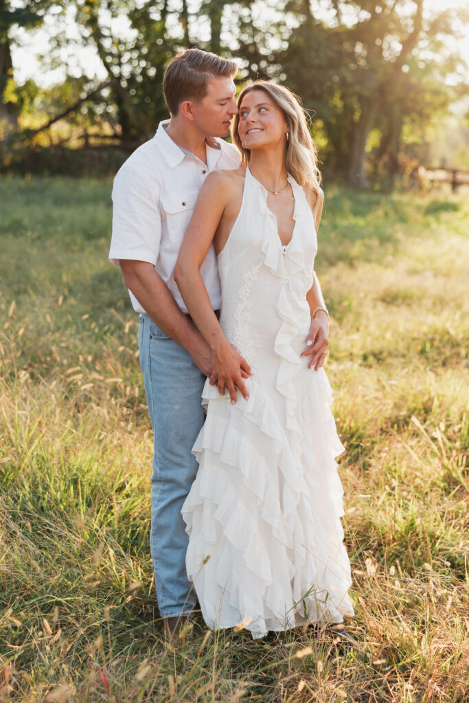 Joyful couple laughing together during their late-summer engagement session in the Virginia countryside.
