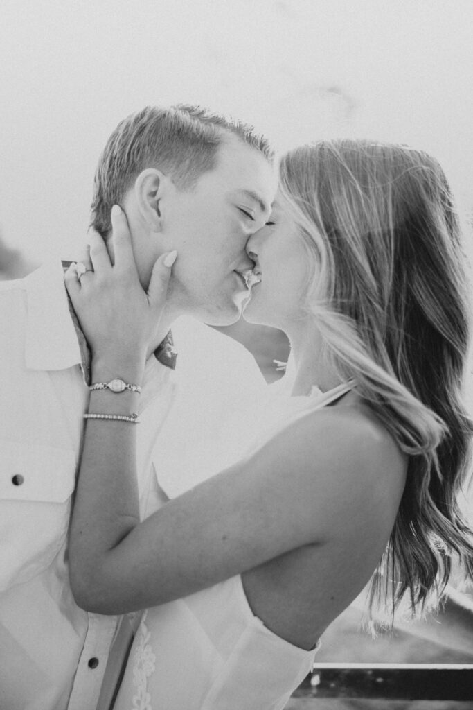Joyful couple laughing together during their late-summer engagement session in the Virginia countryside in black and white