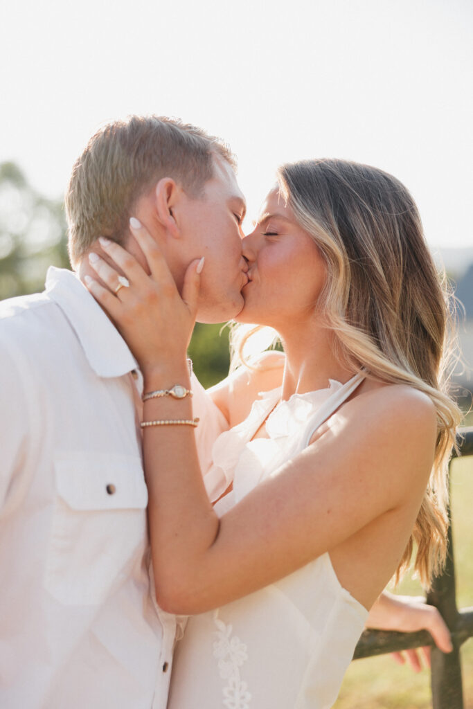 Romantic engagement photo of couple kissing in countryside in Bluemont, Virginia