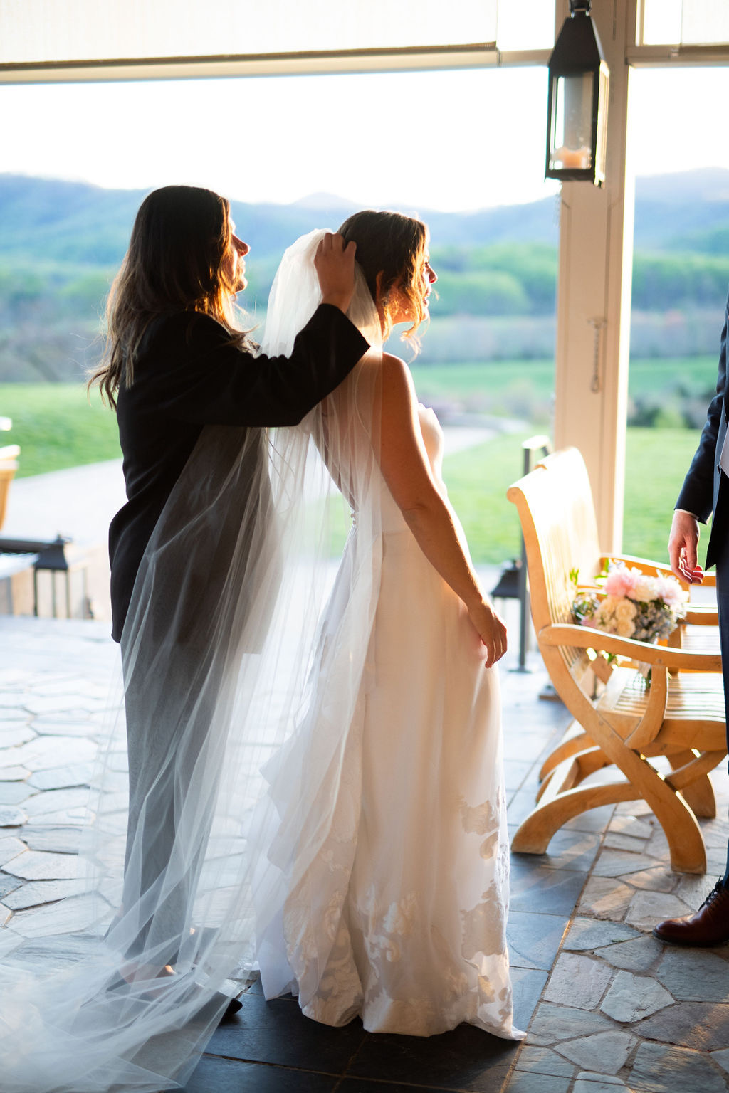 Wedding Planner helping a bride just before her wedding ceremony photo by Sarah Cramer