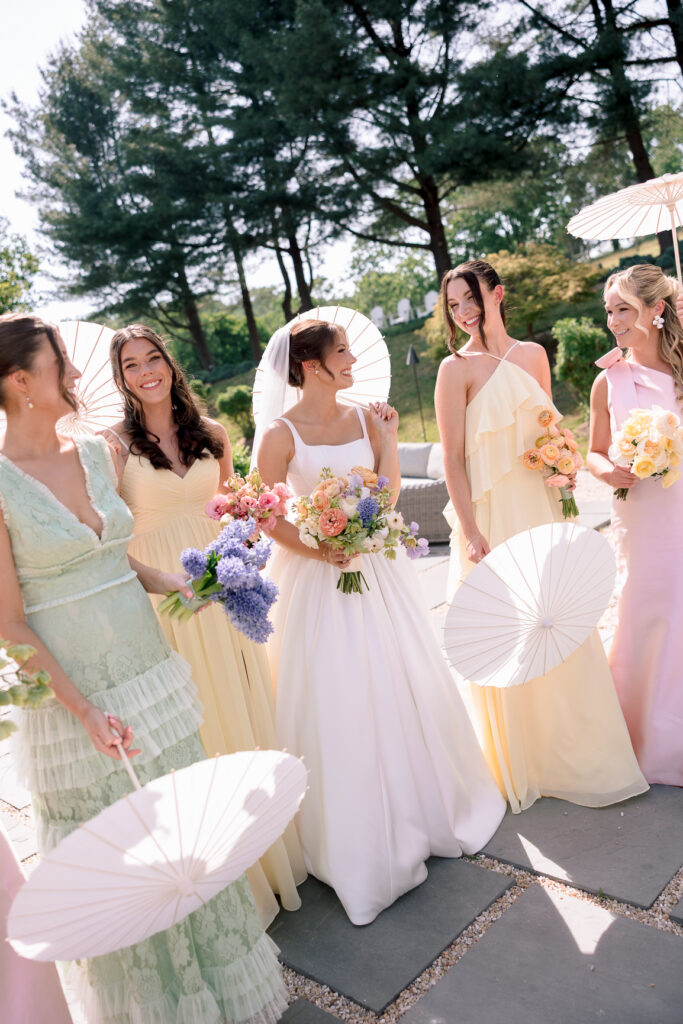 Bride and bridesmaids in colorful mismatched dresses at Tranquility Farm wedding