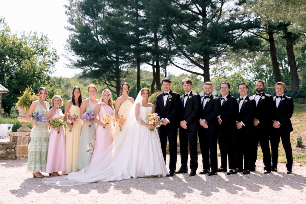 Bride and bridesmaids in colorful mismatched dresses at Tranquility Farm wedding